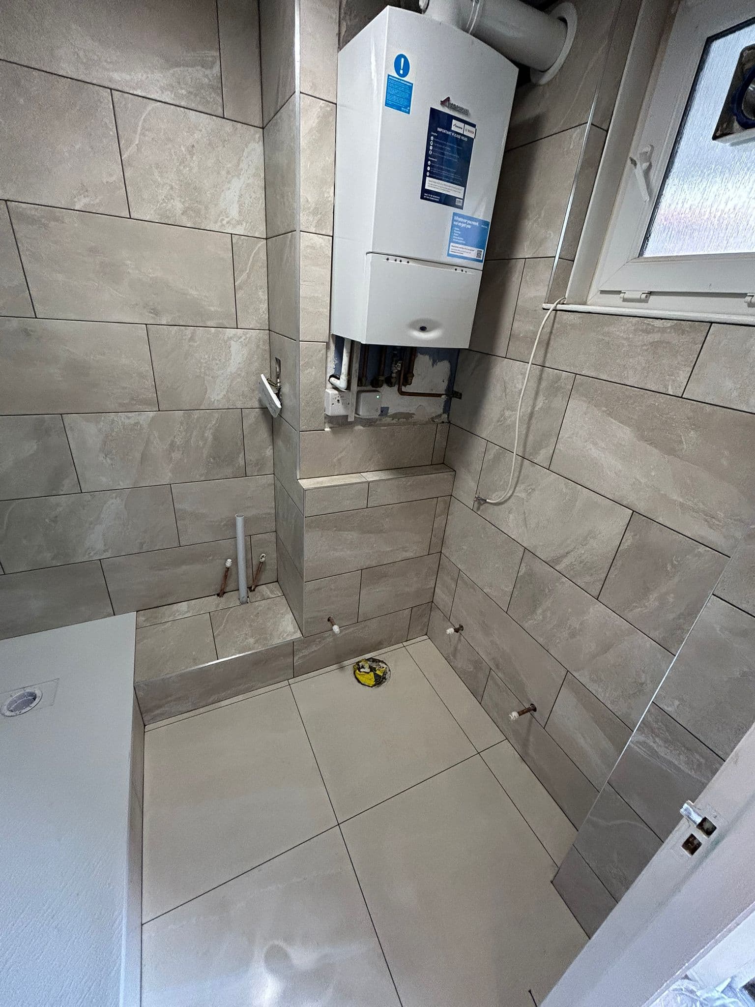 Bathroom Renovation in Battersea: Tiled out, with the boiler boxing finished