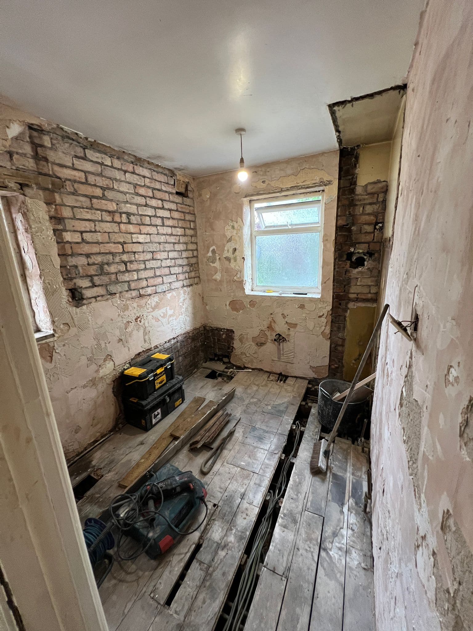 Bathroom to Kitchen Conversion in Chelsea: Room stripped, floorboards coming up