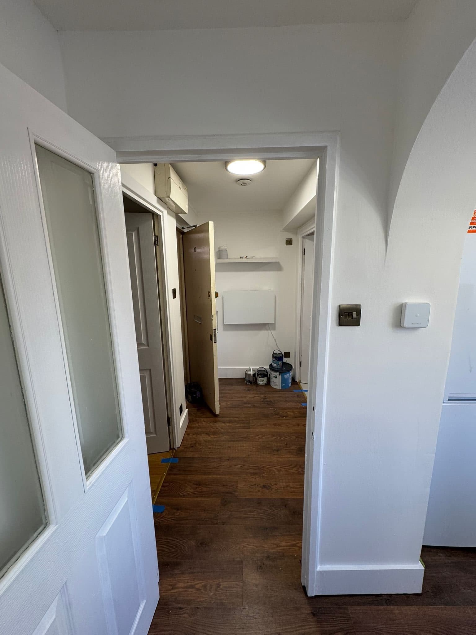 Full Property Refurbishment in Hammersmith: The hallway with new flooring and fresh paintwork