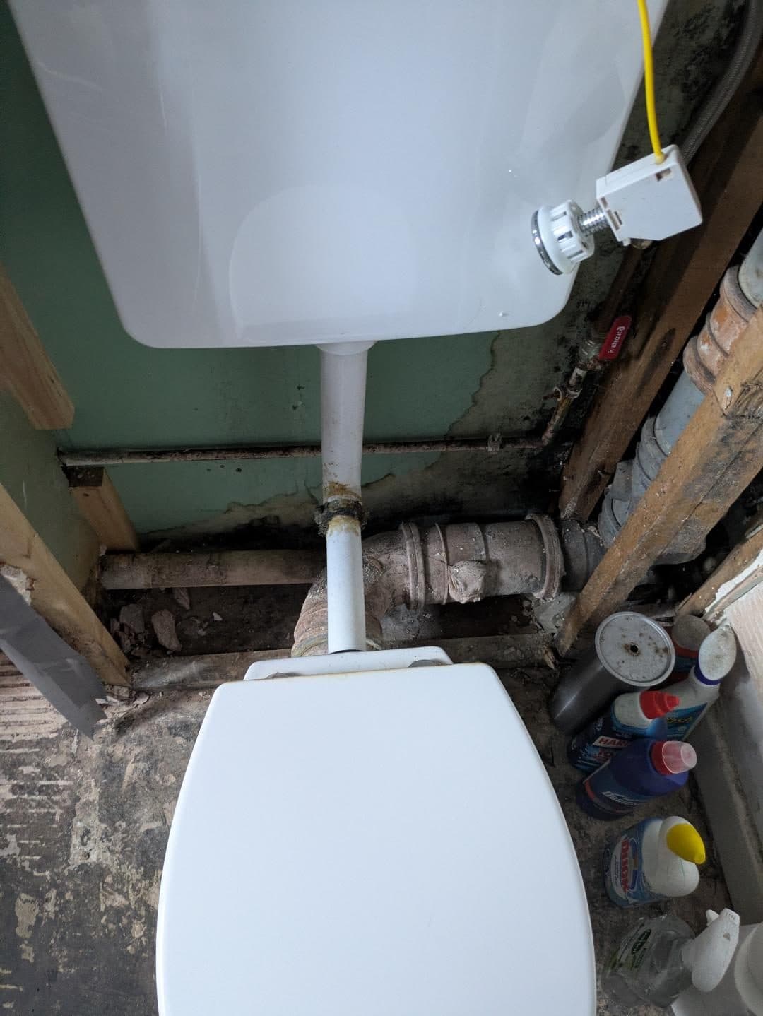 Full Property Refurbishment in Hammersmith: The old toilet, with its pipework exposed behind it