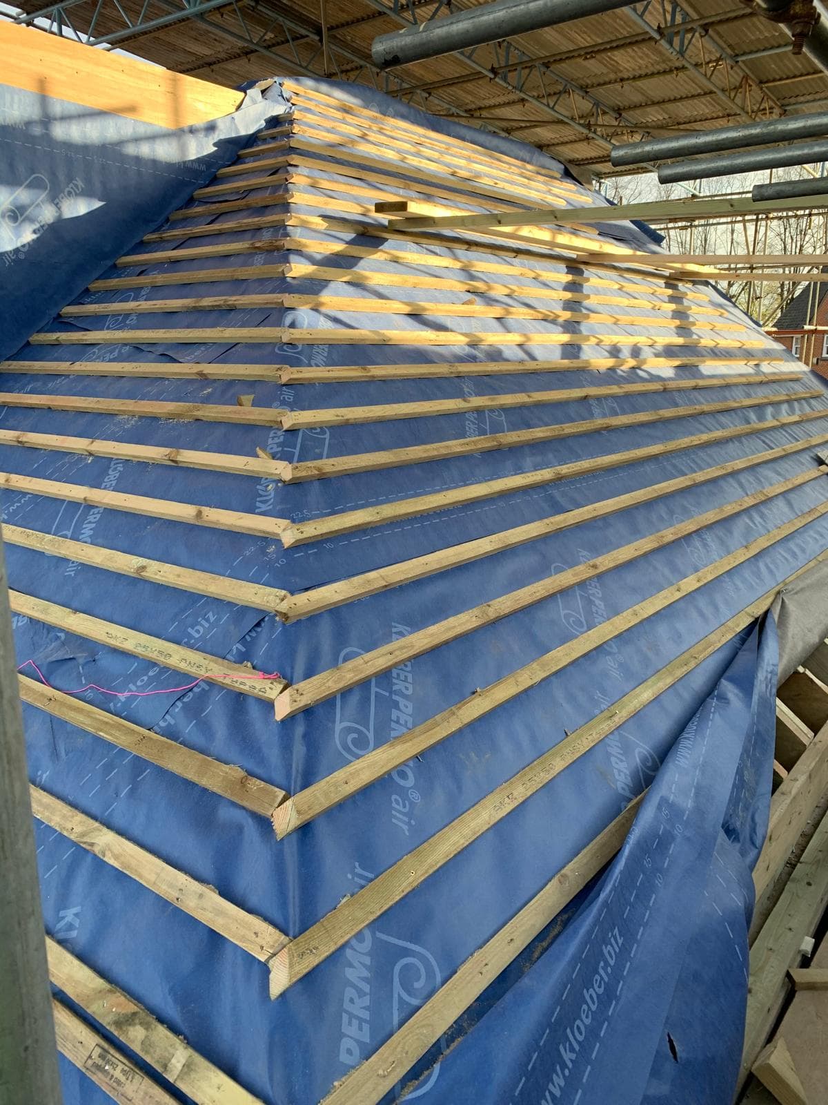 Full House Renovation in Chiswick: The new roof: breather membrane and battens over the hip