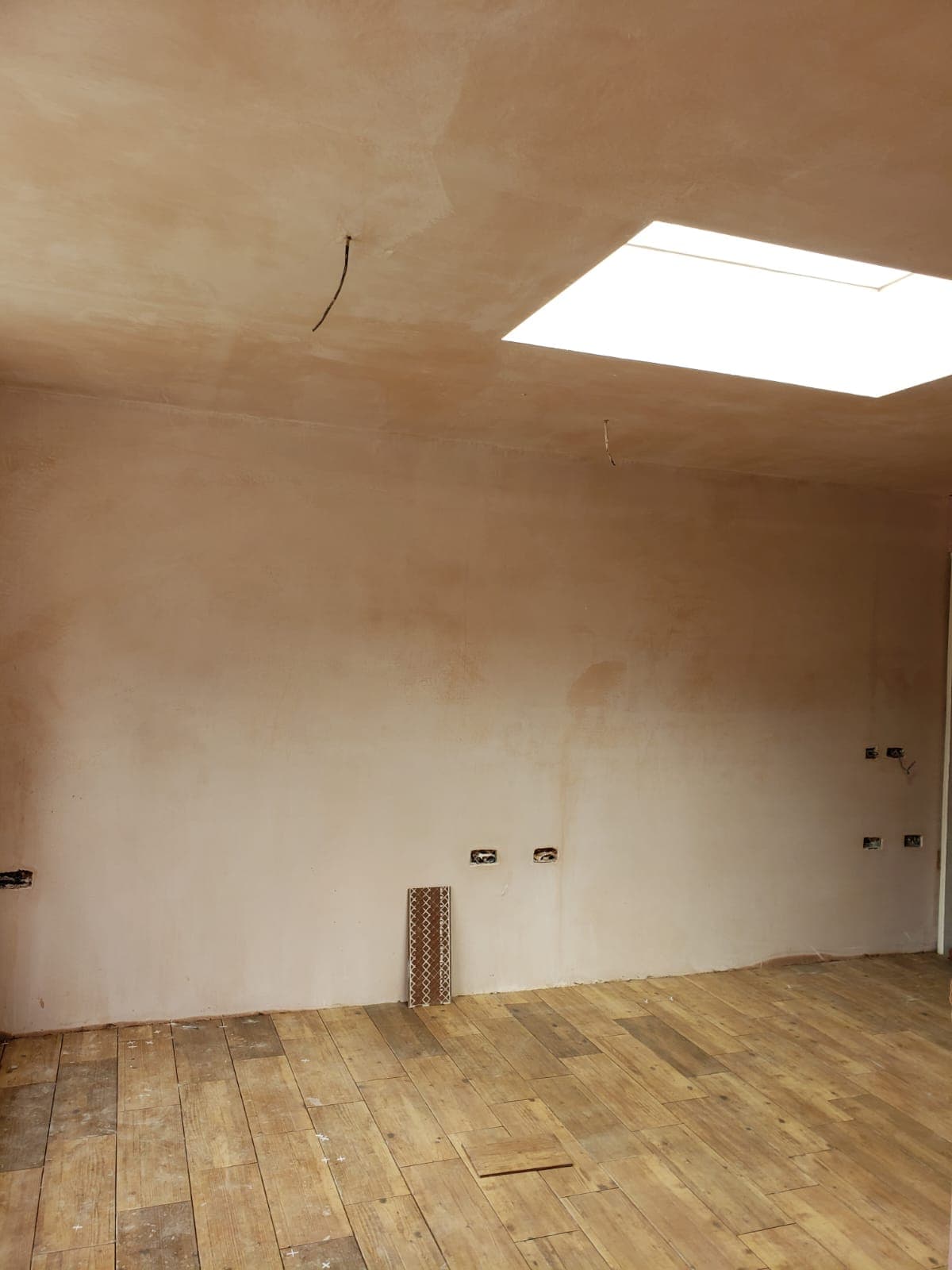 Full House Renovation in Chiswick: A room plastered out under the new rooflight