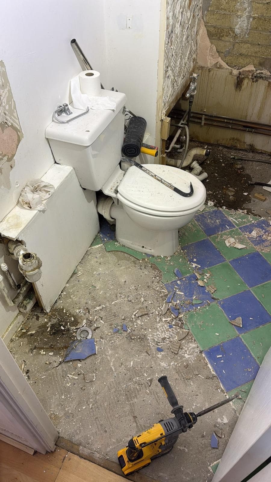 Marble Family Bathroom in Hammersmith: Old suite still in as the chequerboard floor comes up