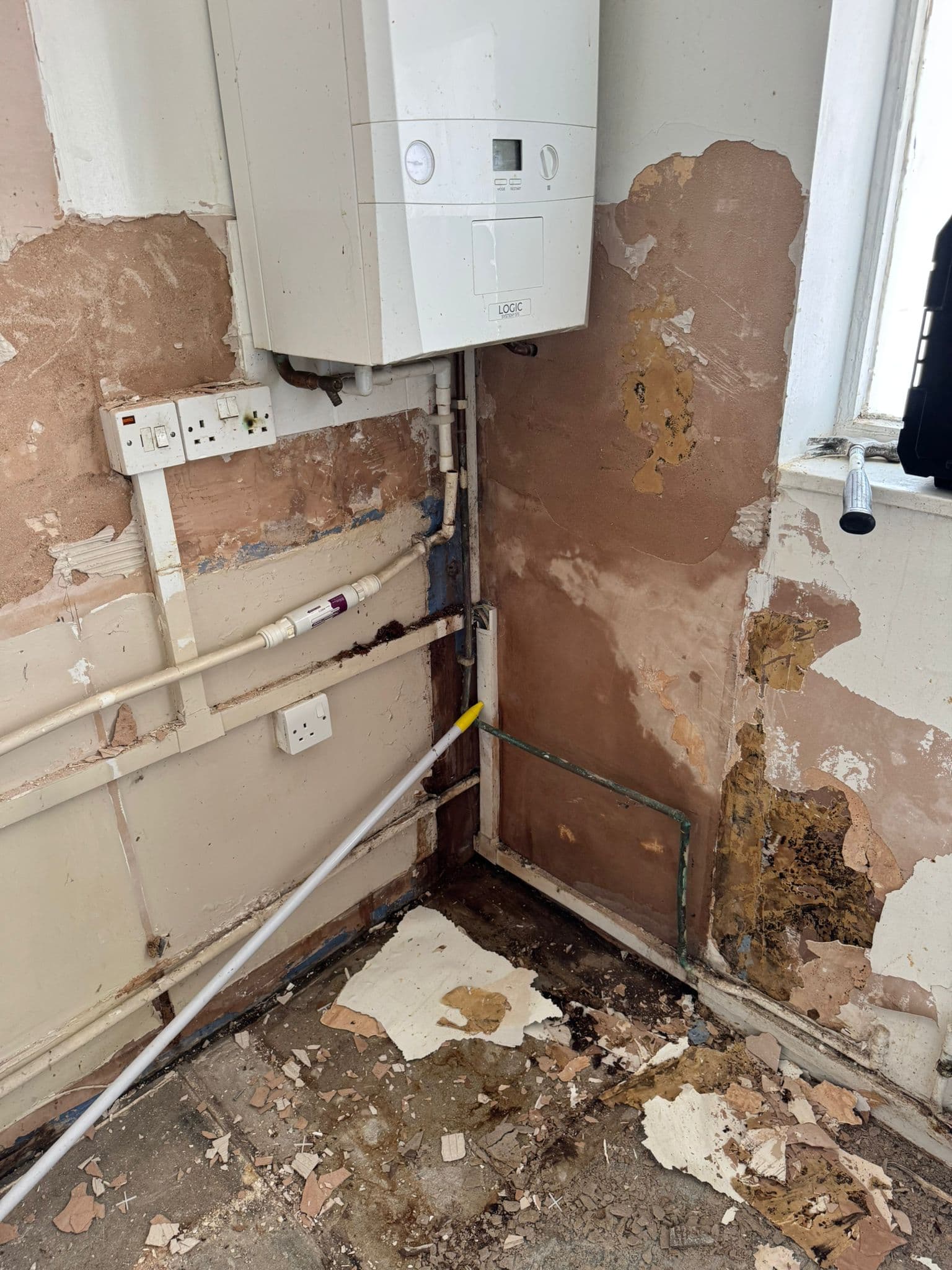 Navy Shaker Kitchen in Mayfair: Perished plaster behind the old boiler