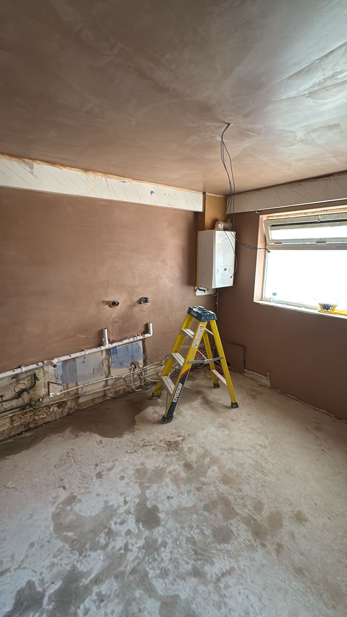 Navy Shaker Kitchen in Mayfair: Walls skimmed out, services capped and waiting