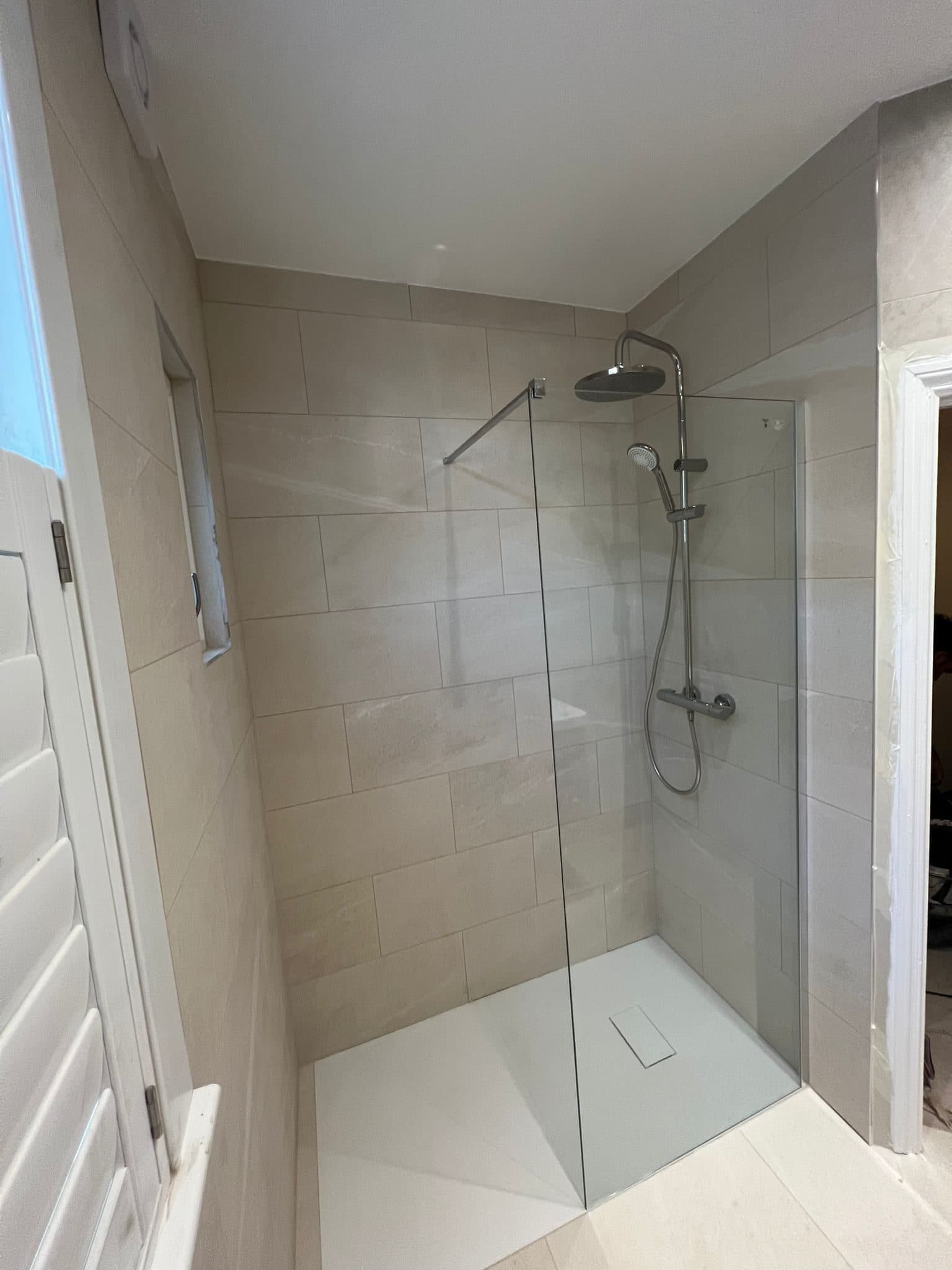 Bathroom Layout Transformation in Tooting: Walk-in shower with a glass screen and rainfall head