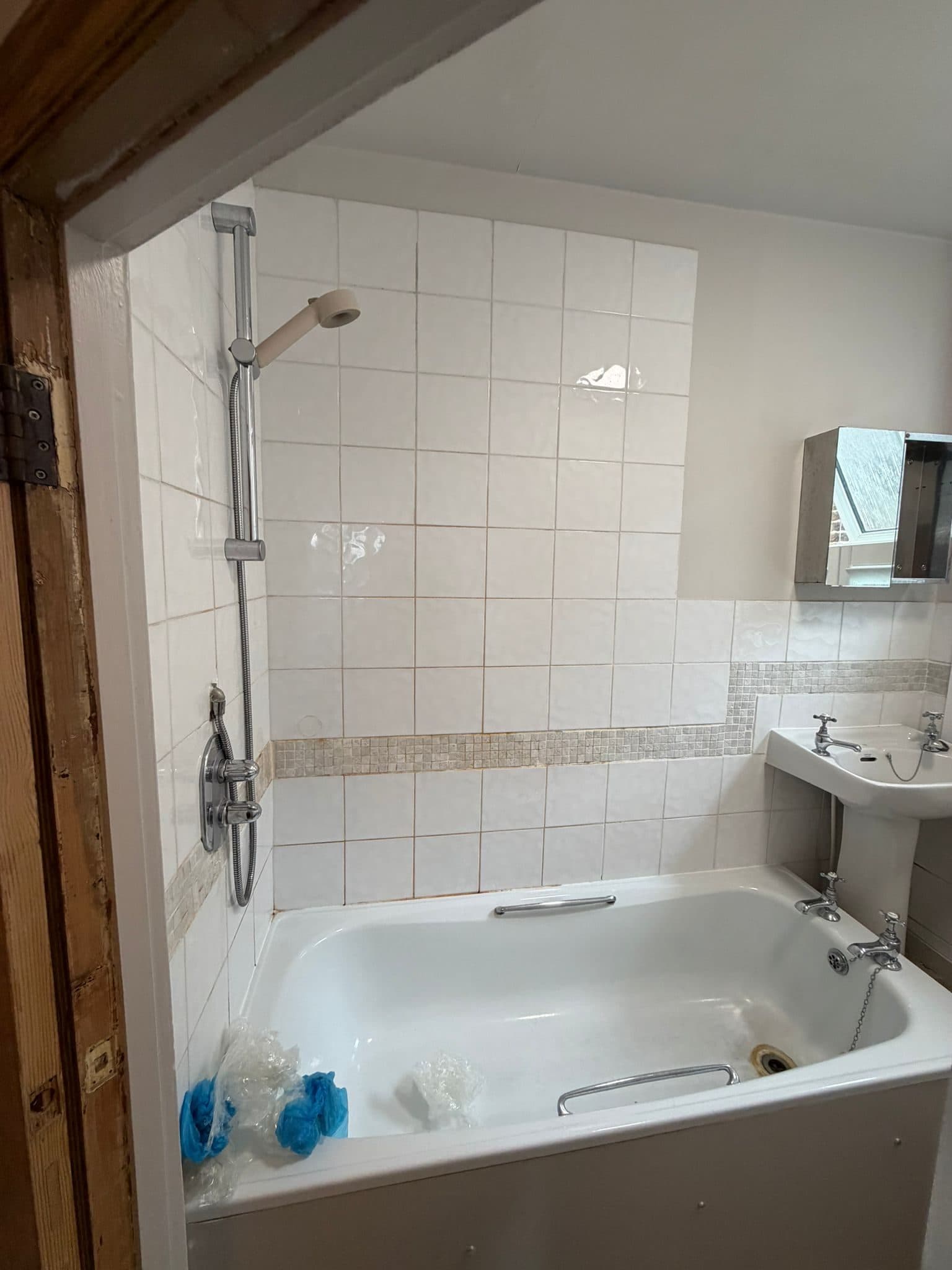 Bathroom Layout Transformation in Tooting: The old shower over the bath, with a mosaic tile border