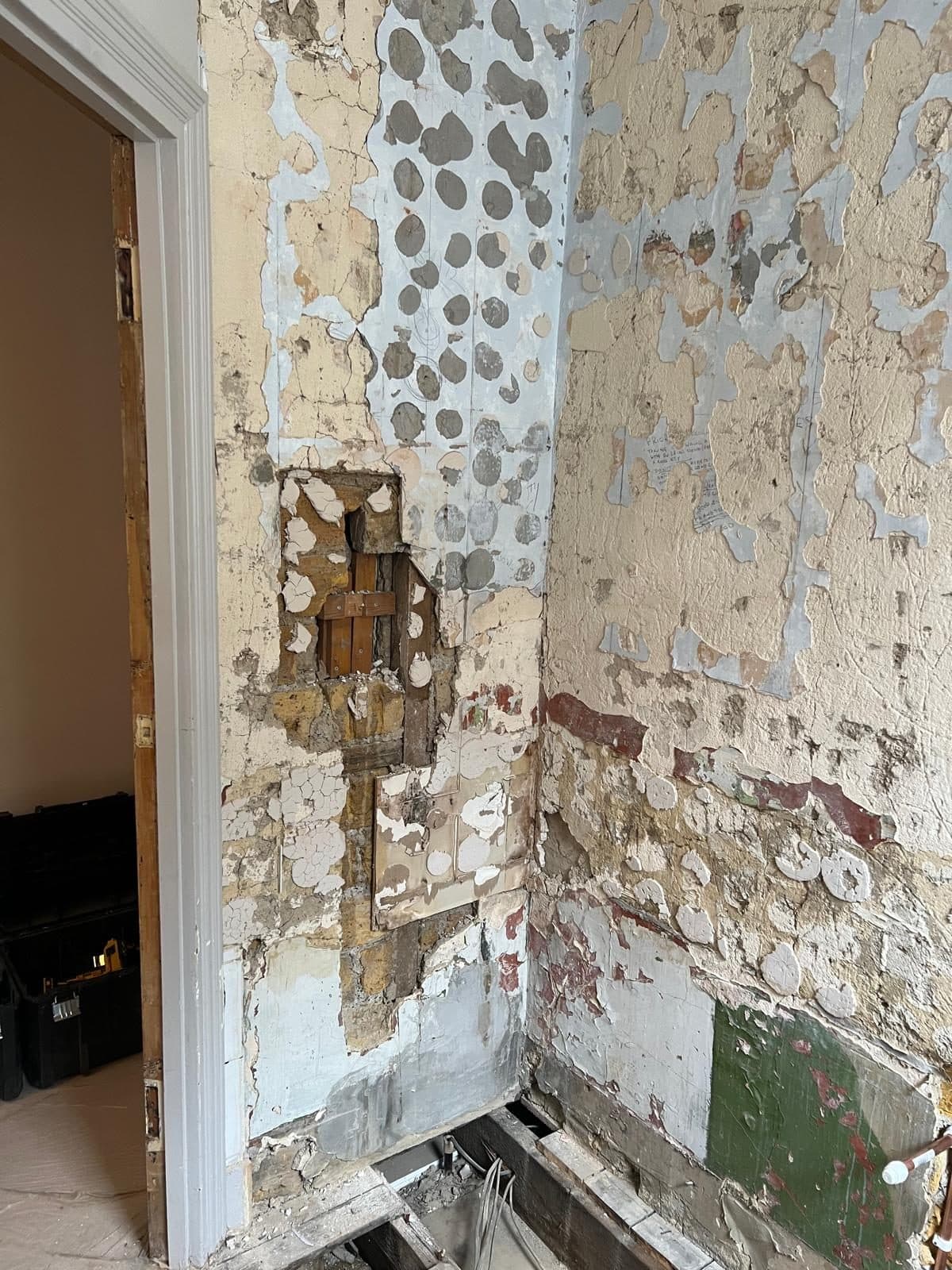 Bathroom Layout Transformation in Tooting: Walls stripped back to the old tile adhesive