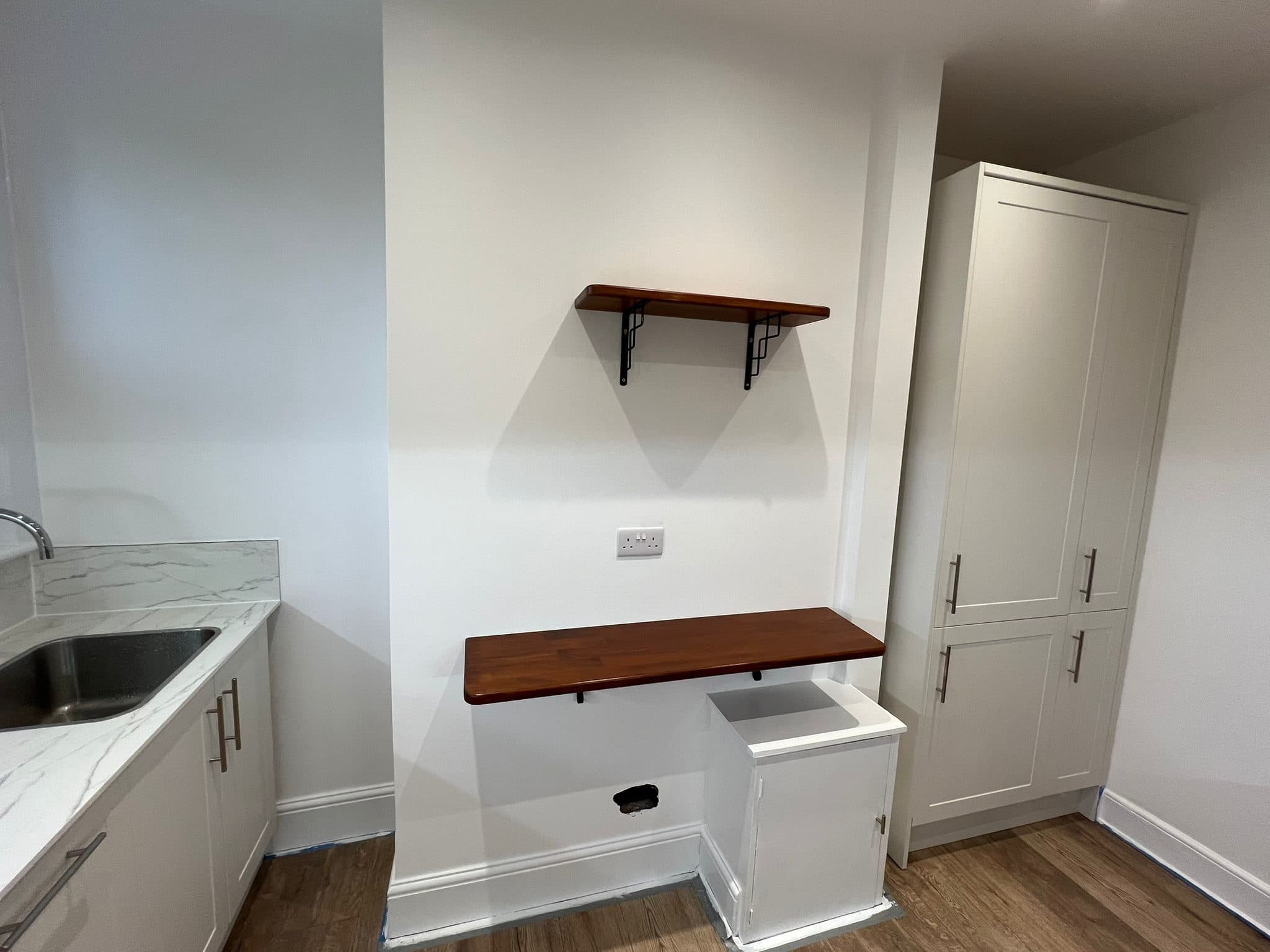 Kitchen Renovation in Tooting: Tall larder units beside the timber counter and shelf